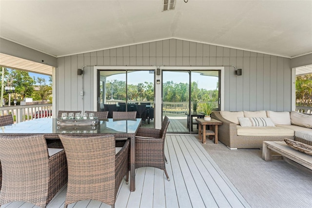 sunroom / solarium featuring outdoor lounge area, outdoor dining area, visible vents, and a healthy amount of sunlight