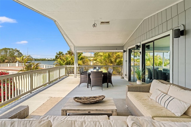 view of patio / terrace with visible vents, an outdoor hangout area, a deck, and outdoor dining area