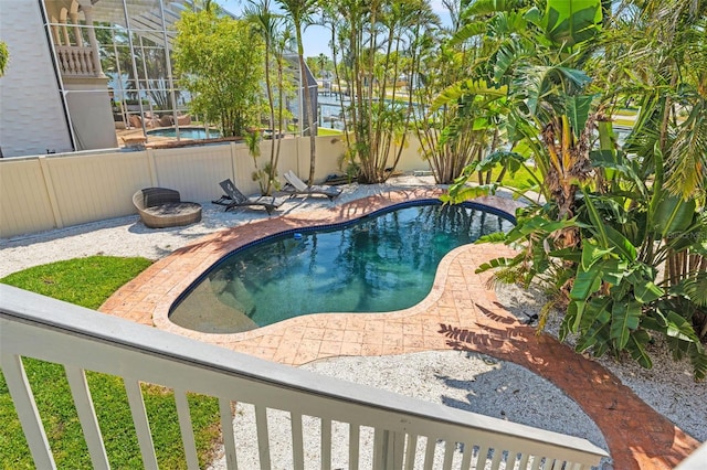 view of swimming pool featuring a fenced backyard, a fenced in pool, and a patio