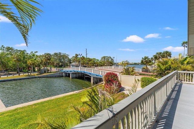 exterior space with a water view and fence