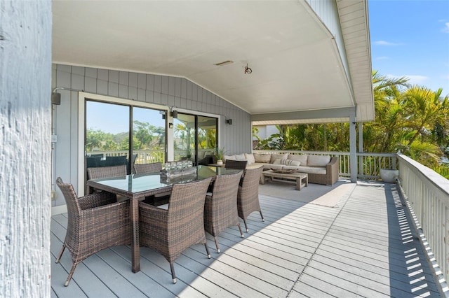 wooden terrace featuring outdoor lounge area and outdoor dining space