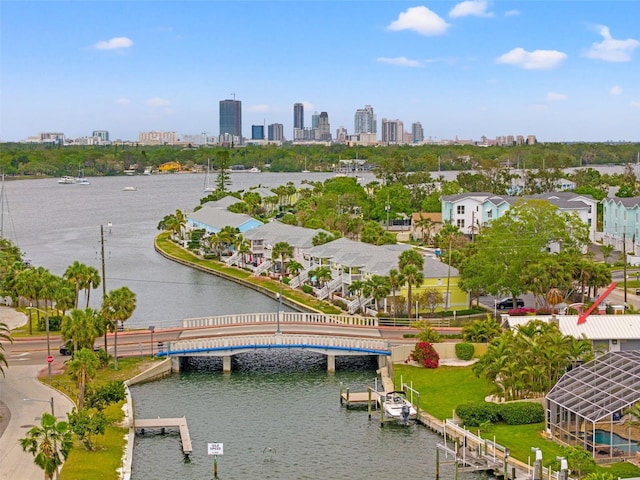 drone / aerial view featuring a city view and a water view