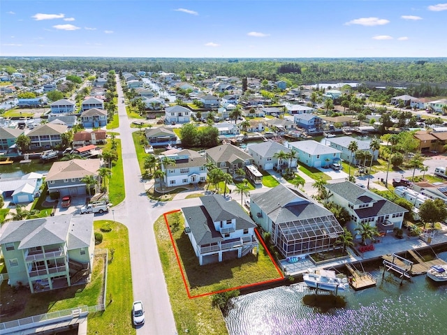 15621 Bertram Dr, Hudson, FL 34667 - aerial perspective of suburban area with property parcel outlined and a large body of water