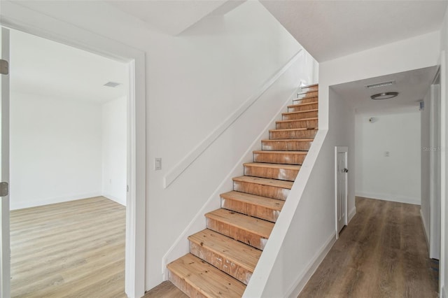 15621 Bertram Dr, Hudson, FL 34667 - stairs with wood finished floors and baseboards