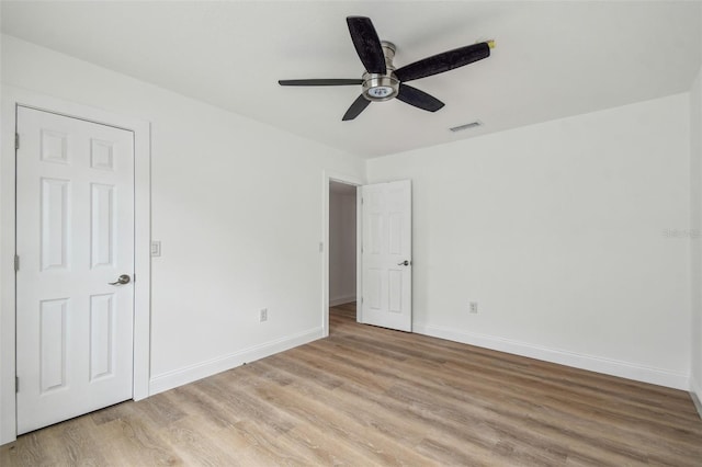 15621 Bertram Dr, Hudson, FL 34667 - unfurnished bedroom featuring light wood-style flooring, baseboards, and a ceiling fan