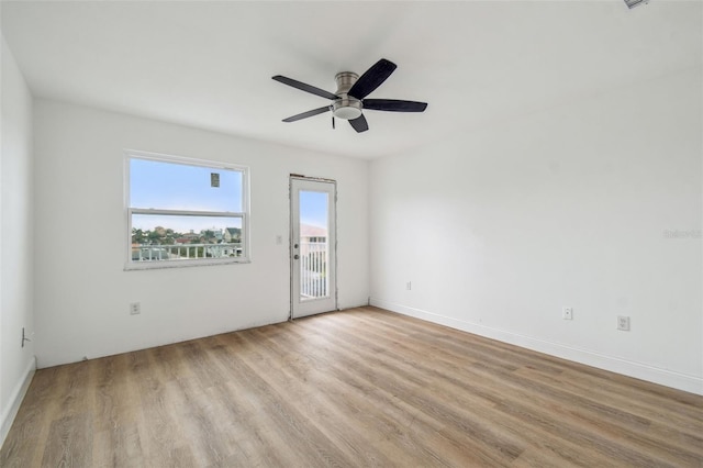 15621 Bertram Dr, Hudson, FL 34667 - spare room with wood finished floors, a ceiling fan, and baseboards