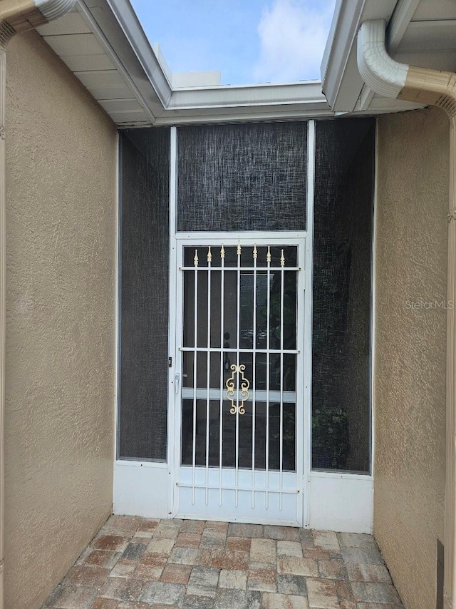 607 Manchester Woods Dr Unit 84, Sun City Center, FL 33573 - doorway to property with stucco siding