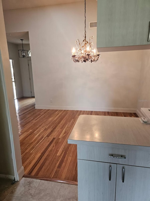607 Manchester Woods Dr Unit 84, Sun City Center, FL 33573 - unfurnished dining area with a chandelier, baseboards, and wood finished floors