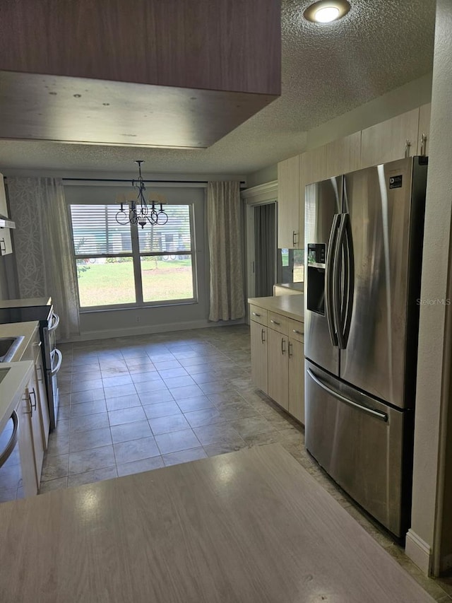 607 Manchester Woods Dr Unit 84, Sun City Center, FL 33573 - kitchen with stainless steel fridge with ice dispenser, a chandelier, a textured ceiling, light countertops, and modern cabinets