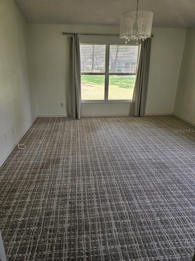 607 Manchester Woods Dr Unit 84, Sun City Center, FL 33573 - empty room with carpet floors and a chandelier