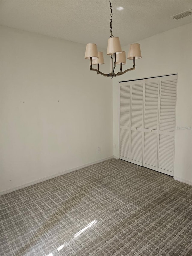 607 Manchester Woods Dr Unit 84, Sun City Center, FL 33573 - unfurnished bedroom featuring a chandelier, carpet flooring, a textured ceiling, and baseboards