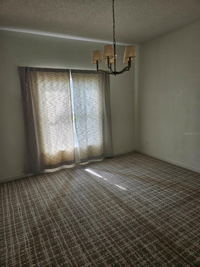 607 Manchester Woods Dr Unit 84, Sun City Center, FL 33573 - carpeted spare room featuring a chandelier and a textured ceiling