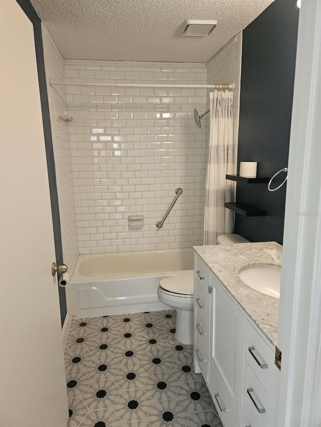 607 Manchester Woods Dr Unit 84, Sun City Center, FL 33573 - full bathroom featuring a textured ceiling, shower / bath combination with curtain, toilet, tile patterned flooring, and vanity