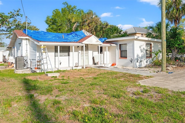 8615 Jackson Springs Rd, Tampa, FL 33615 - view of front of home with a front lawn, covered porch, and central AC unit
