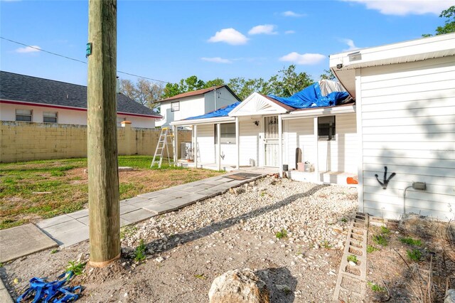 8615 Jackson Springs Rd, Tampa, FL 33615 - back of property with roof with shingles and fence