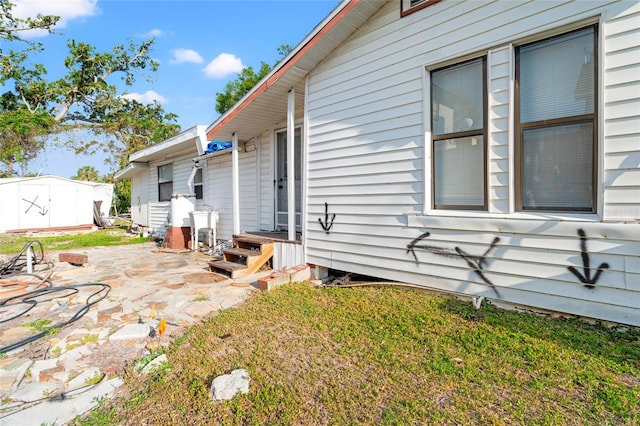 8615 Jackson Springs Rd, Tampa, FL 33615 - view of home's exterior with a lawn and a patio area