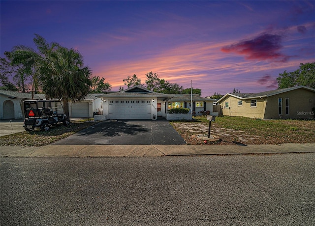 view of front of home with driveway and a garage