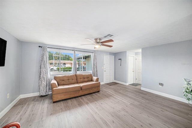 unfurnished living room with a ceiling fan, baseboards, light wood-style floors, and visible vents