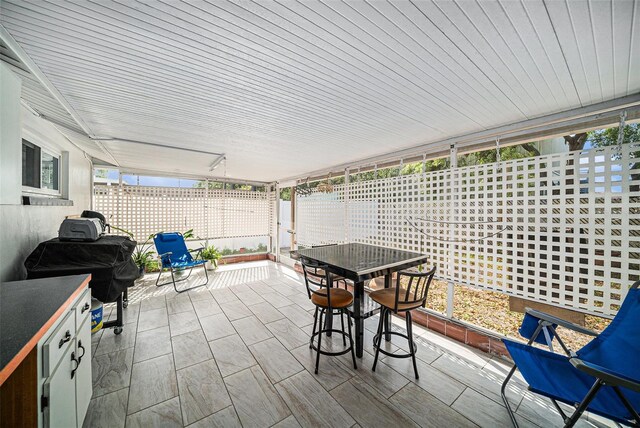 view of patio with outdoor dining area and area for grilling