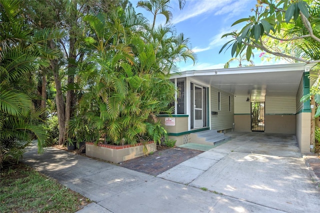 921 24th Ave N, Saint Petersburg, FL 33704 - view of front facade featuring driveway, an attached carport, and entry steps