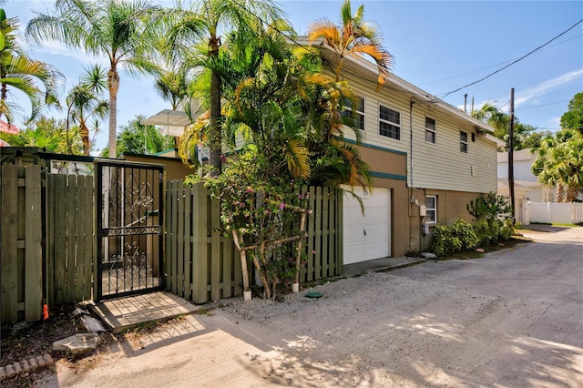 921 24th Ave N, Saint Petersburg, FL 33704 - view of home's exterior with a gate, a garage, and driveway
