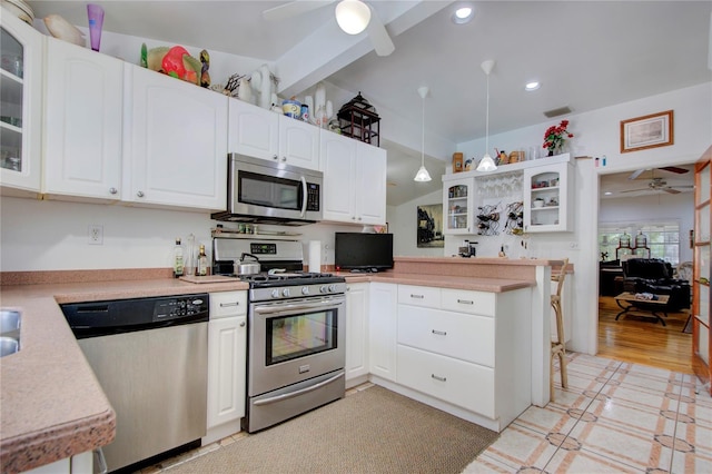 921 24th Ave N, Saint Petersburg, FL 33704 - kitchen featuring stainless steel appliances, ceiling fan, light countertops, white cabinets, and recessed lighting