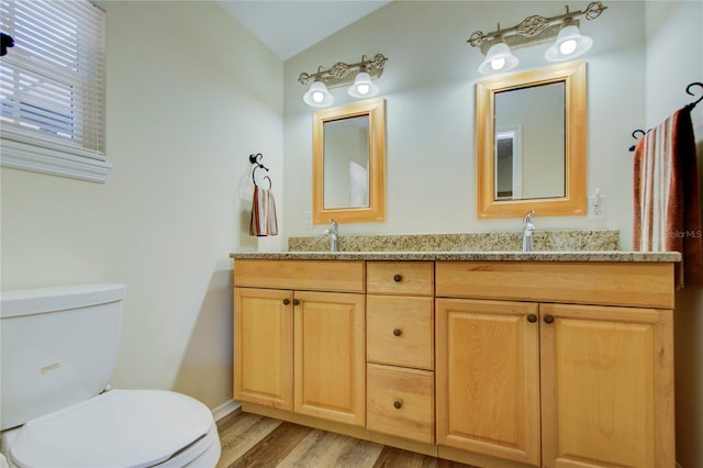 921 24th Ave N, Saint Petersburg, FL 33704 - bathroom with toilet, double vanity, wood finished floors, and vaulted ceiling
