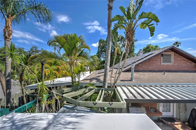 921 24th Ave N, Saint Petersburg, FL 33704 - view of side of property featuring solar panels, roof with shingles, and a standing seam roof