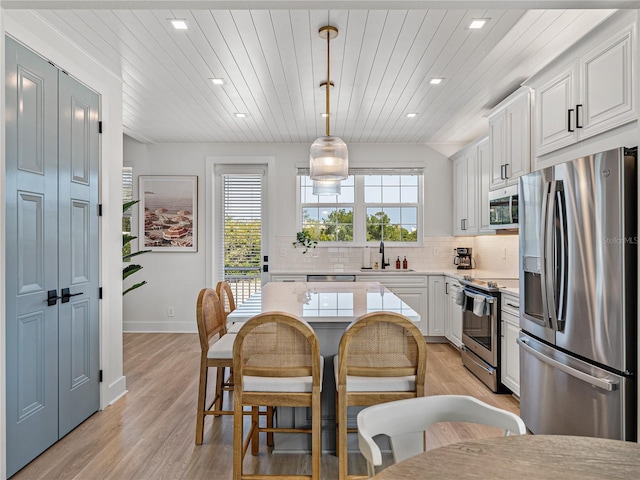 4215 Saltwater Pearl Way, Cortez, FL 34215 - kitchen featuring appliances with stainless steel finishes, light countertops, recessed lighting, decorative backsplash, and white cabinets