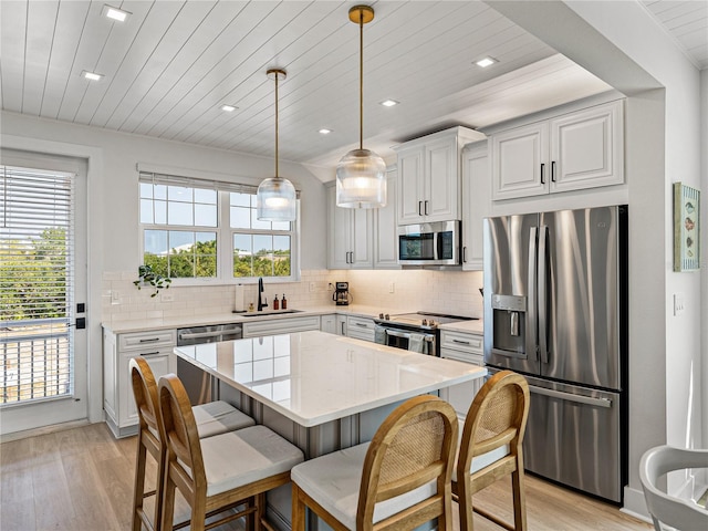 4215 Saltwater Pearl Way, Cortez, FL 34215 - kitchen with appliances with stainless steel finishes, light wood finished floors, plenty of natural light, decorative backsplash, and wooden ceiling