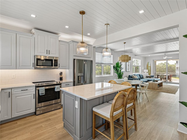4215 Saltwater Pearl Way, Cortez, FL 34215 - kitchen featuring stainless steel appliances, a wooden ceiling with exposed beams, open floor plan, light wood-type flooring, and a kitchen island