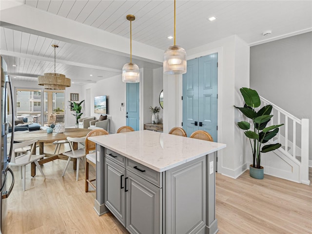 4215 Saltwater Pearl Way, Cortez, FL 34215 - kitchen featuring gray cabinetry, light wood-style flooring, a center island, open floor plan, and a wooden ceiling with exposed beams