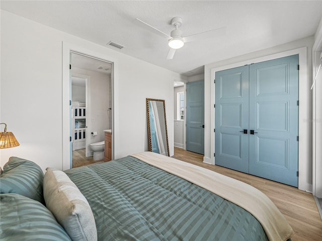 4215 Saltwater Pearl Way, Cortez, FL 34215 - bedroom with light wood finished floors, ensuite bathroom, a closet, and ceiling fan