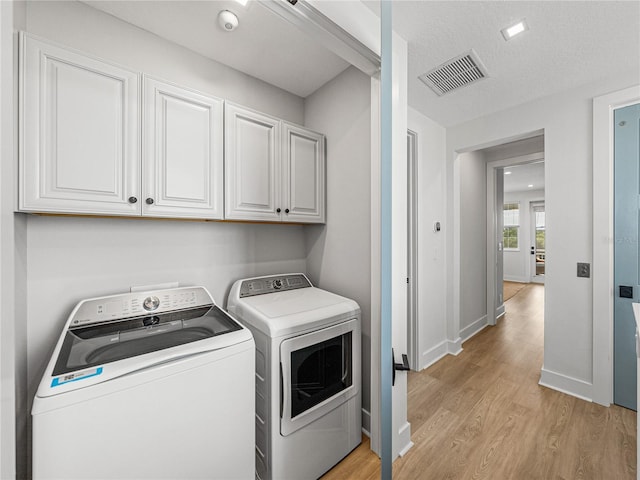 4215 Saltwater Pearl Way, Cortez, FL 34215 - washroom featuring cabinet space, washing machine and dryer, and light wood-type flooring