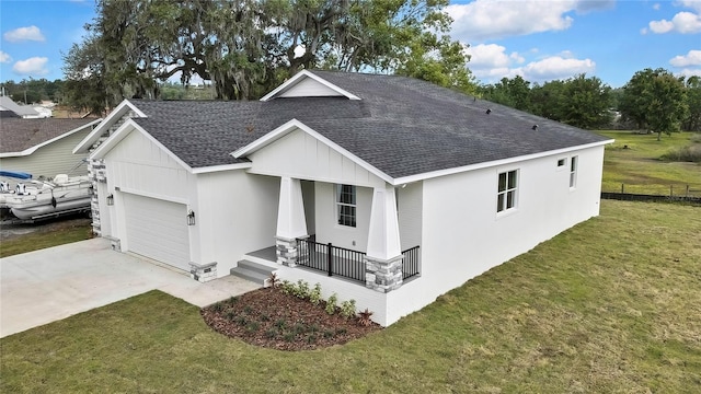view of front of home featuring driveway, a shingled roof, covered porch, and a garage