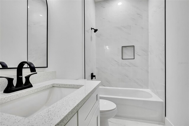 full bath featuring toilet, vanity, and shower / bathtub combination