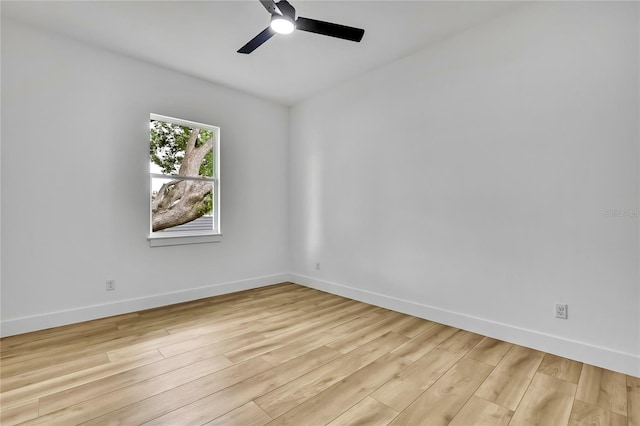 spare room with a ceiling fan, baseboards, and light wood-type flooring