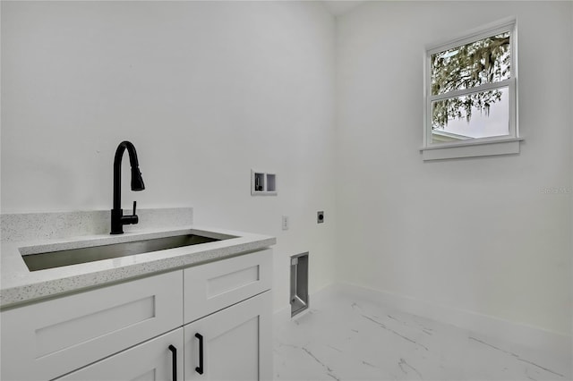 washroom with baseboards, marble finish floor, a sink, electric dryer hookup, and cabinet space