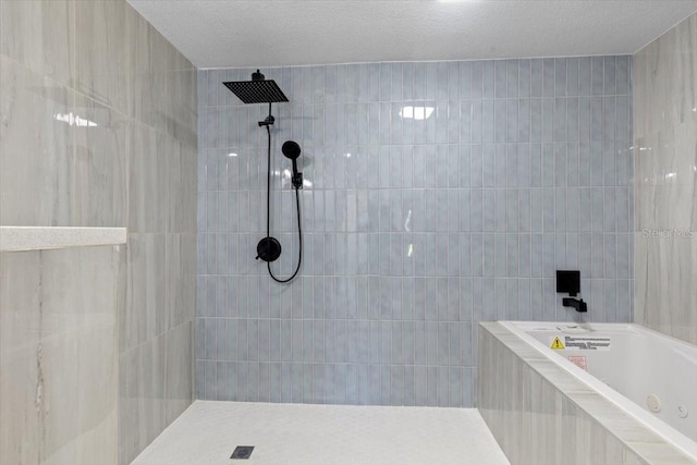 bathroom featuring tile walls, tiled shower, and a jetted tub