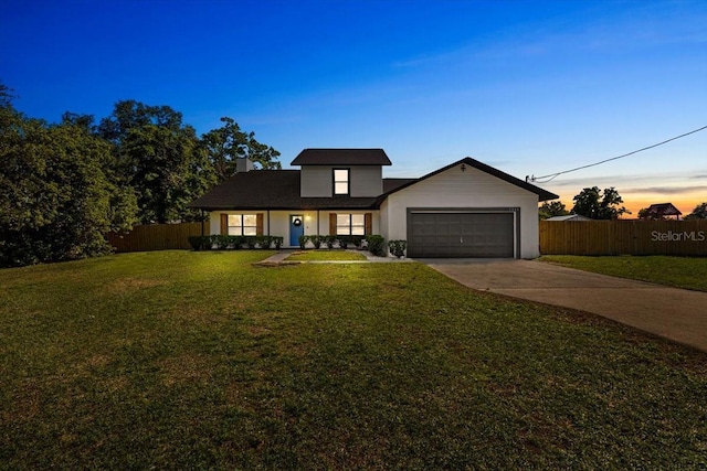 view of front of property with a chimney, driveway, a garage, fence, and a lawn