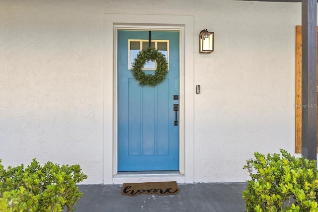 doorway to property with stucco siding
