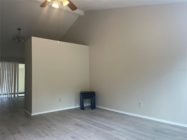8804 Briar Hollow Ct, Tampa, FL 33634 - spare room featuring a wood stove, beam ceiling, wood finished floors, high vaulted ceiling, and ceiling fan with notable chandelier