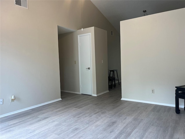 8804 Briar Hollow Ct, Tampa, FL 33634 - unfurnished room featuring visible vents, baseboards, lofted ceiling, and wood finished floors