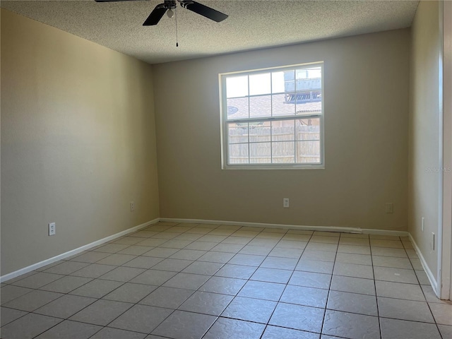 8804 Briar Hollow Ct, Tampa, FL 33634 - spare room with baseboards, a textured ceiling, ceiling fan, and light tile patterned floors
