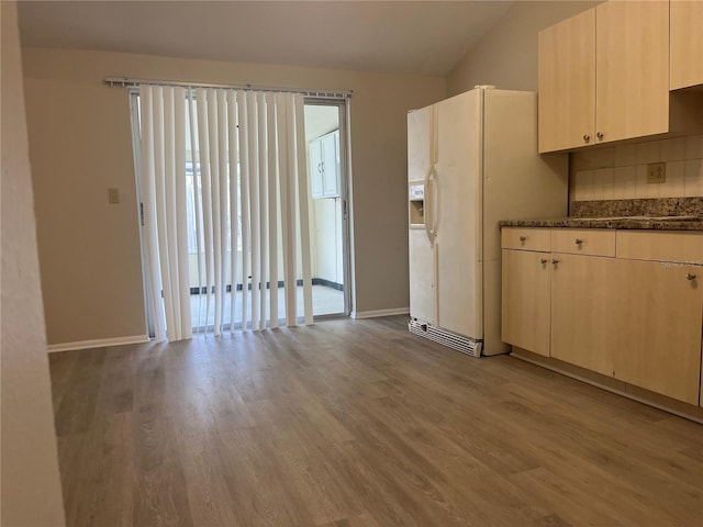 8804 Briar Hollow Ct, Tampa, FL 33634 - kitchen featuring light wood-style floors, baseboards, backsplash, and dark stone countertops
