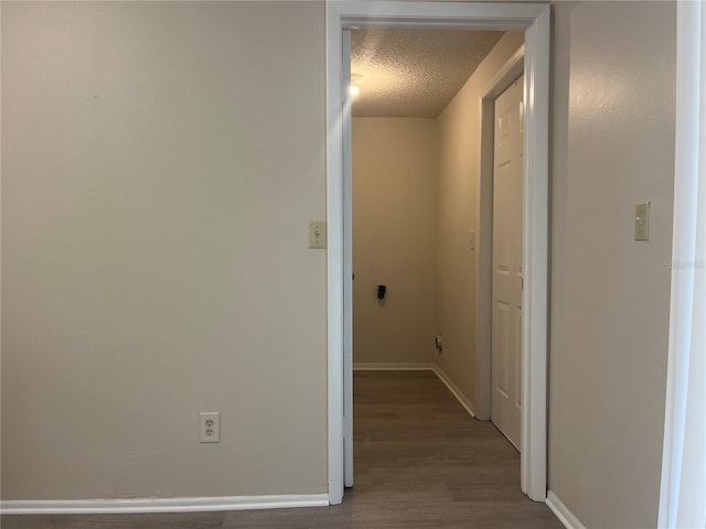 8804 Briar Hollow Ct, Tampa, FL 33634 - hallway featuring baseboards, a textured ceiling, and wood finished floors
