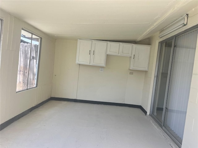 8804 Briar Hollow Ct, Tampa, FL 33634 - spare room featuring baseboards and finished concrete floors