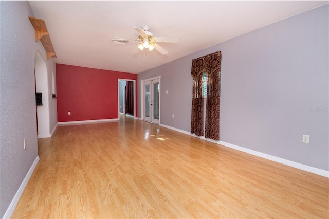 empty room with light wood-type flooring, baseboards, and a ceiling fan