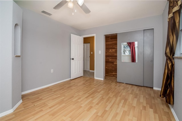 unfurnished bedroom with light wood-style flooring, baseboards, and visible vents