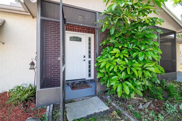 entrance to property with brick siding